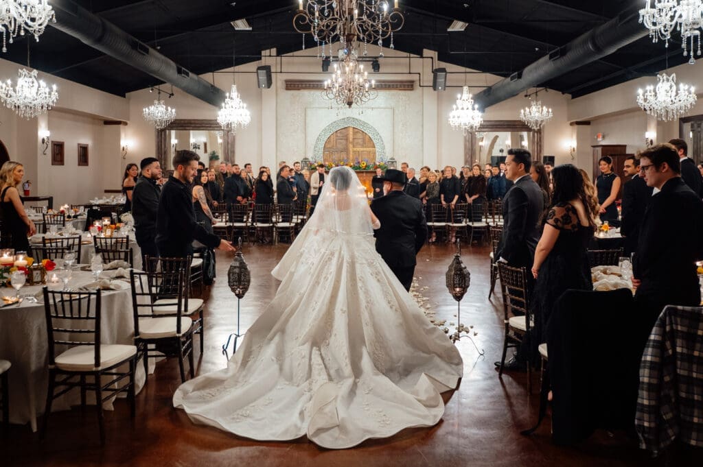 Rain forced the ceremony indoors at Madera Estates.  Guests were asked to attend wearing black.