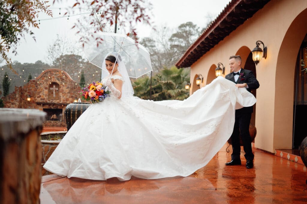 Gracie and Ethan didn't let a few raindrops get in the way of a beautiful celebration. The ceremony was moved indoors. And this beautiful dress almost caught on fire. (Photo by JMG Photography Houston)
